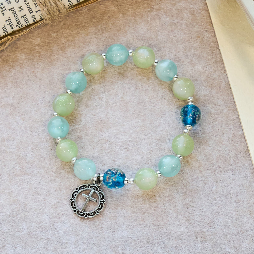 Bracciale con perline glitterate che cambiano colore ai raggi UV di Christianartworkshop con croce decorata: brilla in tonalità fedeli - image 1