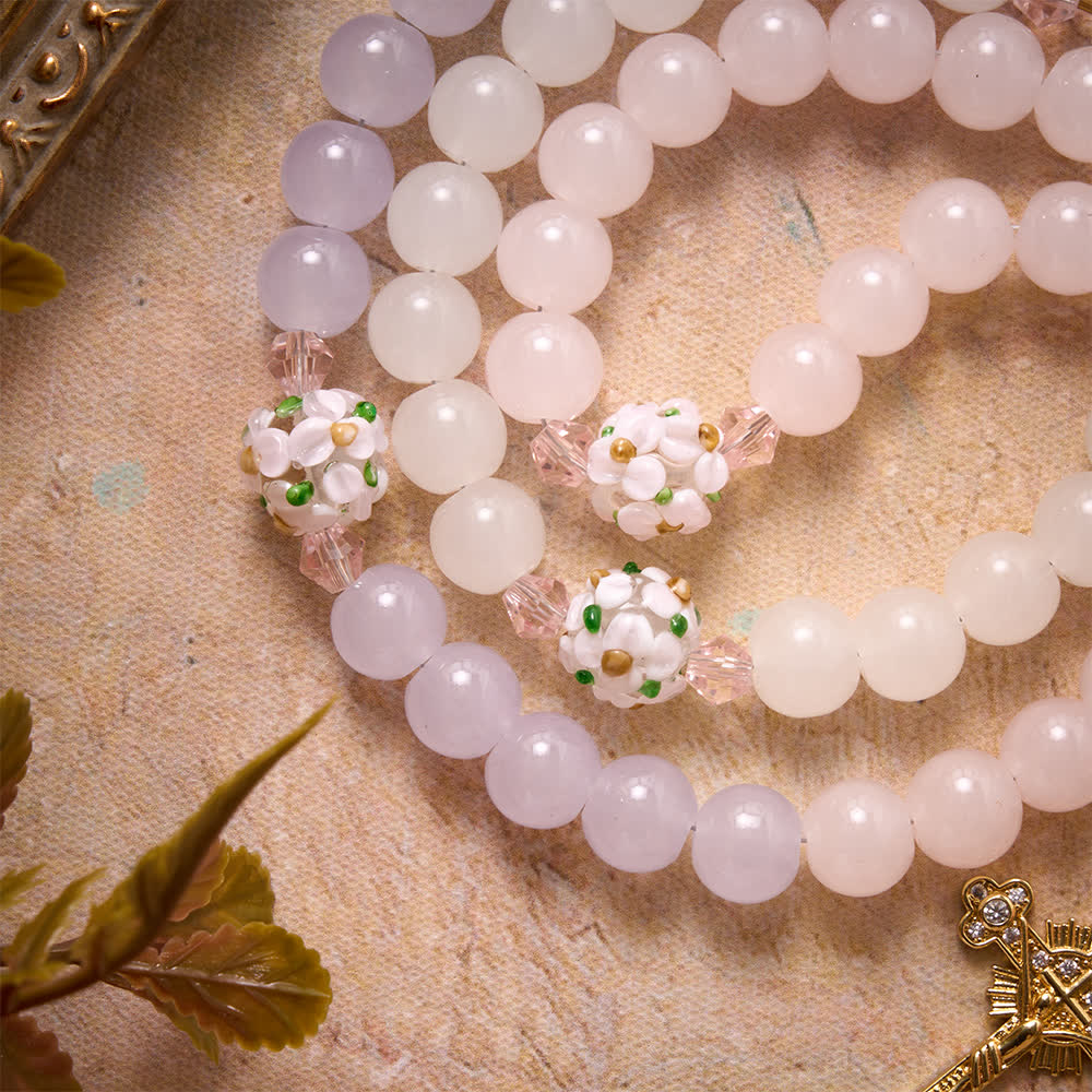 Christianartworkshop Rosario con perline di vetro a motivi floreali, sfumature di rosa, lavanda e bianco latte, croce con strass e medaglione della Madonna. - image 6