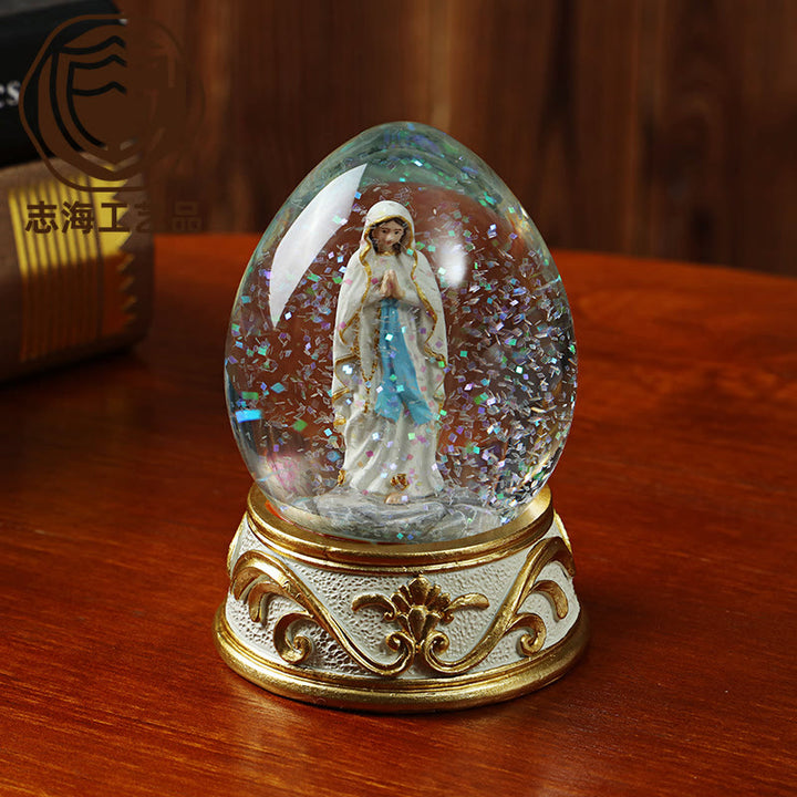 Christianartworkshop Globo di neve glitterato a forma di uovo con statua della Madonna in preghiera: emblema di pura supplica celeste. - Nostra Signora - image 0
