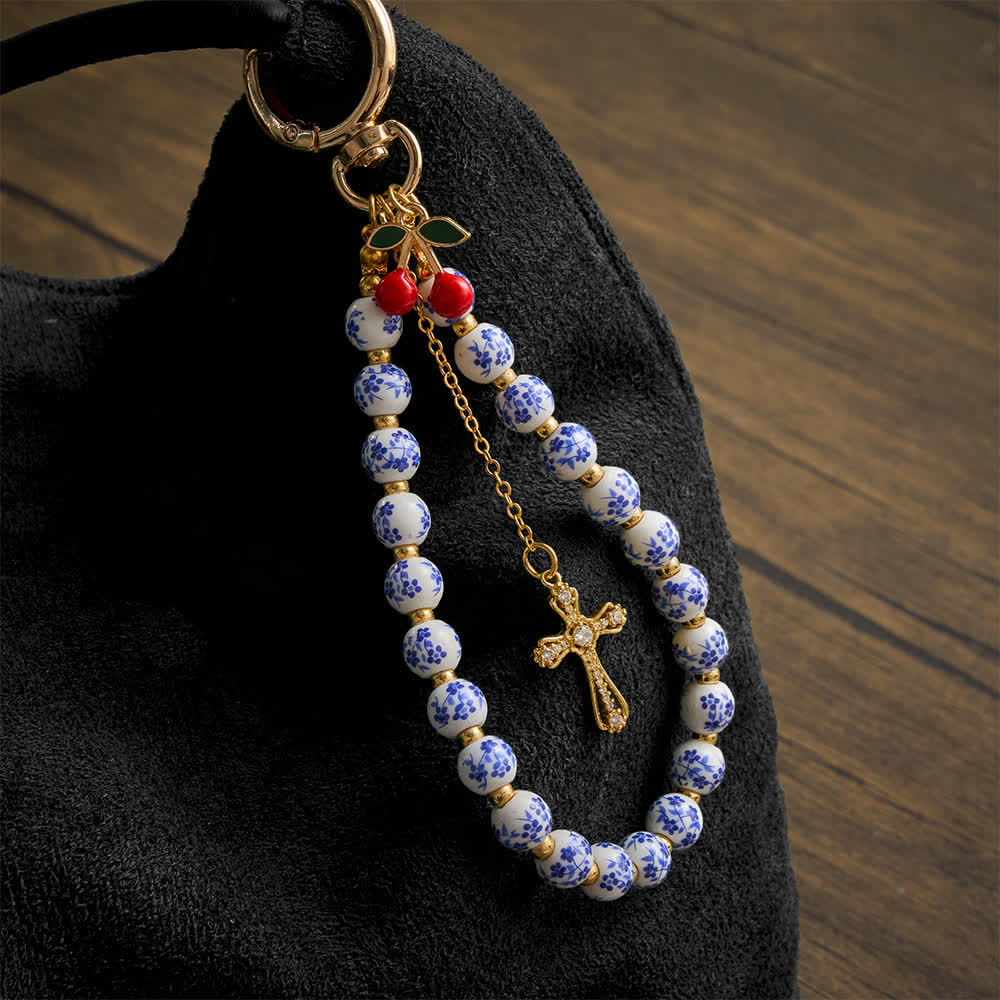 Christianartworkshop Ciondolo per borsa a forma di ciliegia con decorazioni floreali in porcellana e croce gioiello: emblema di dolce grazia celeste. - Ciondolo floreale in ceramica a forma di ciliegia - image 0